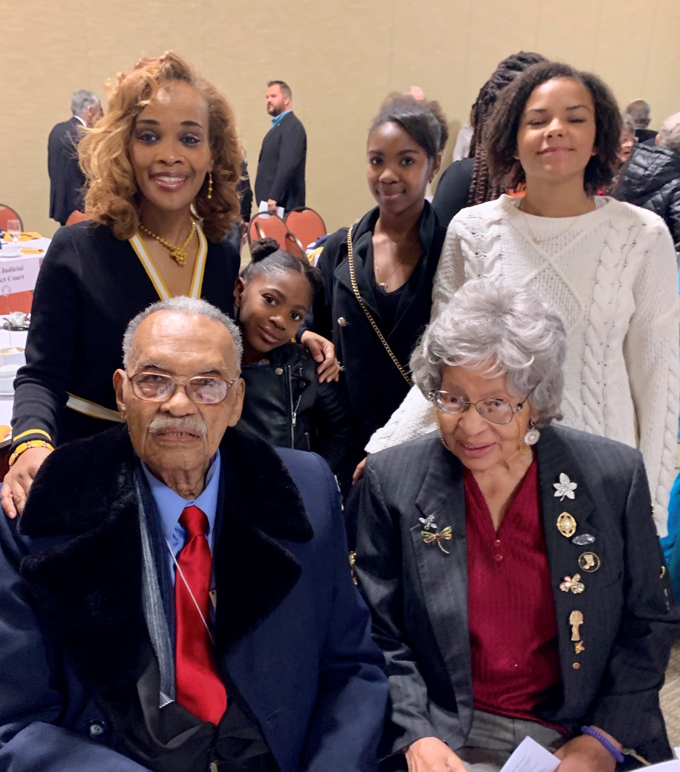 Director of Black Programs poses for a photo with attendees of the Martin Luther King, Jr. celebration
