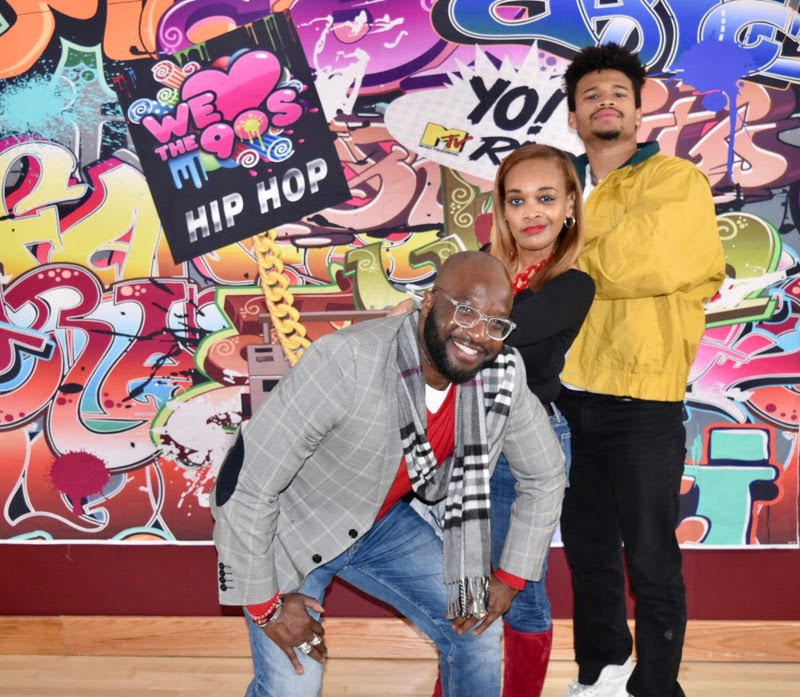 Attendees at the hip-hop event during 2020 Black History Month standing in front of graffiti wall. 