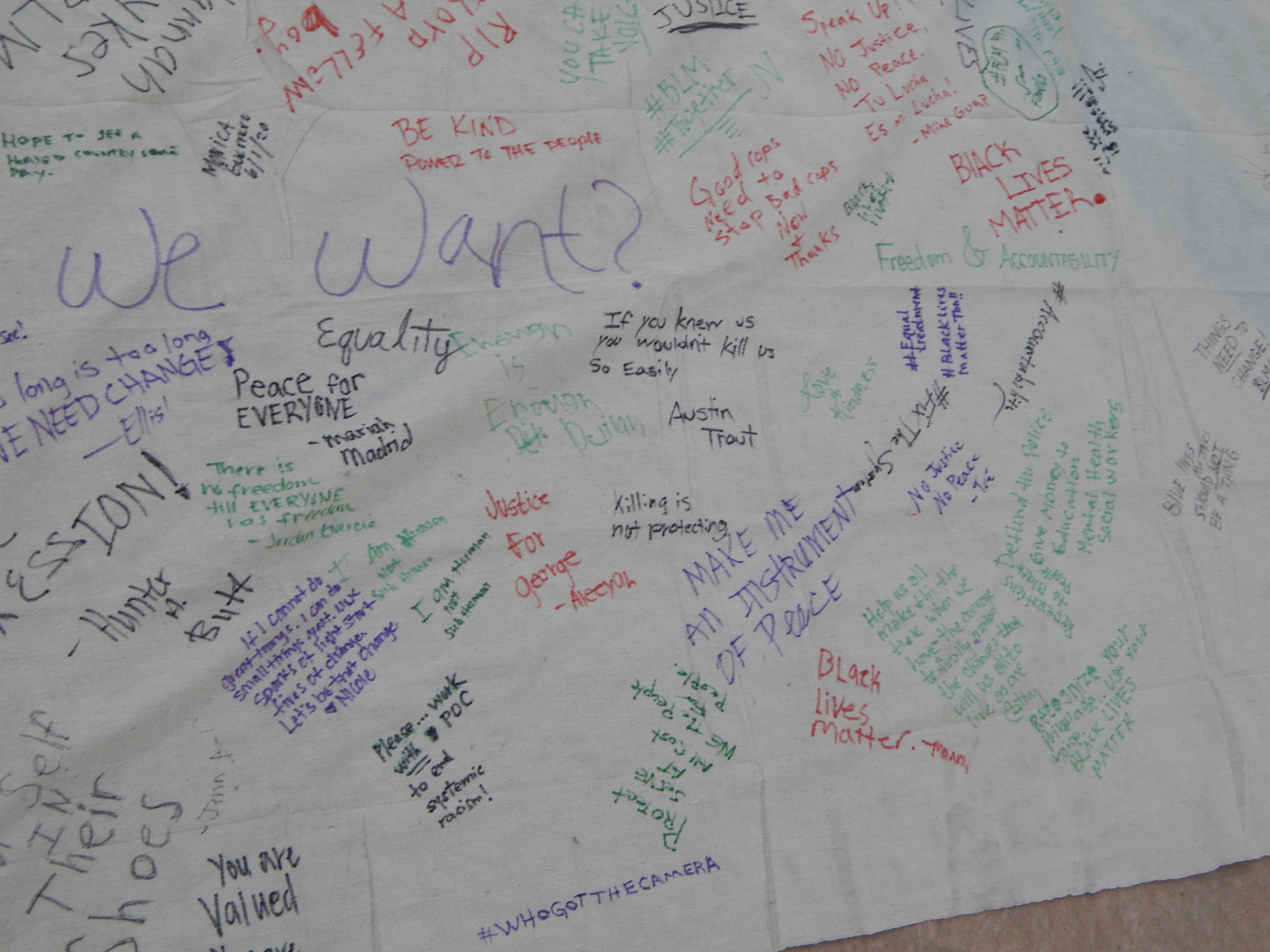 Attendees sign a banner of what they want to see. 